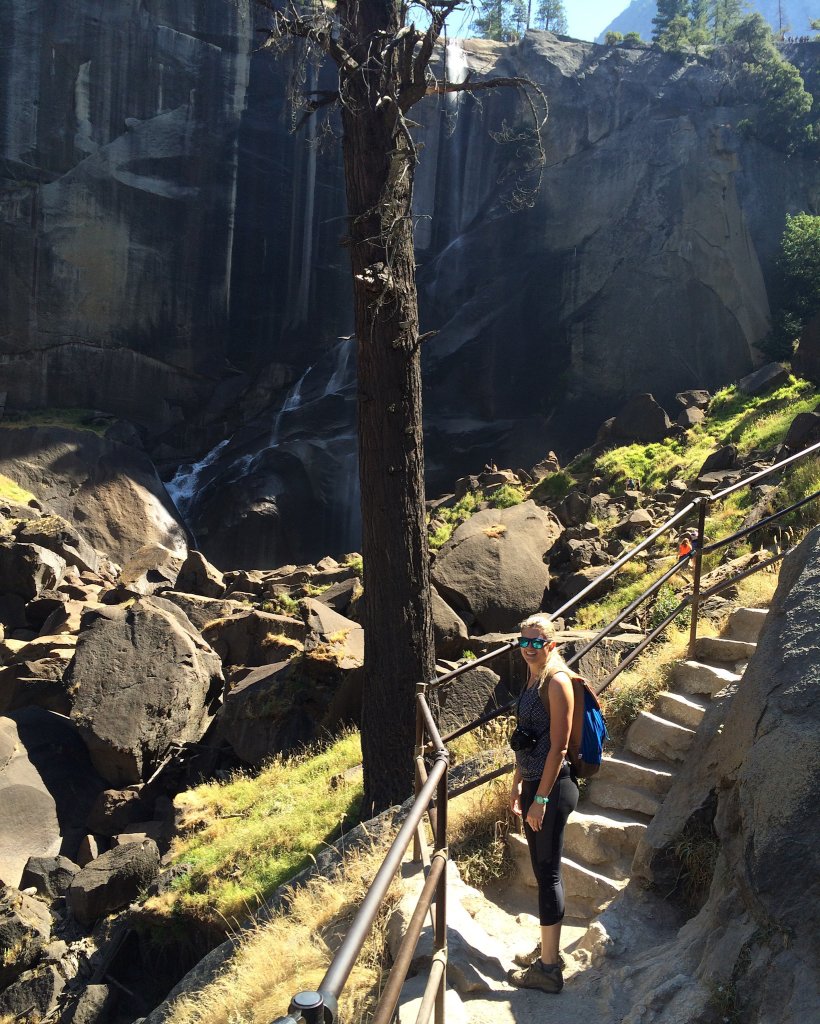 a woman standing on steps on the Mist Trail
