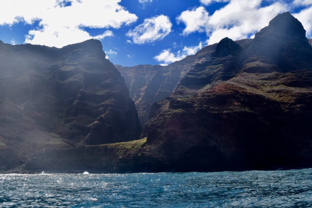 a view of the Na Pali coast mountains from the ocean