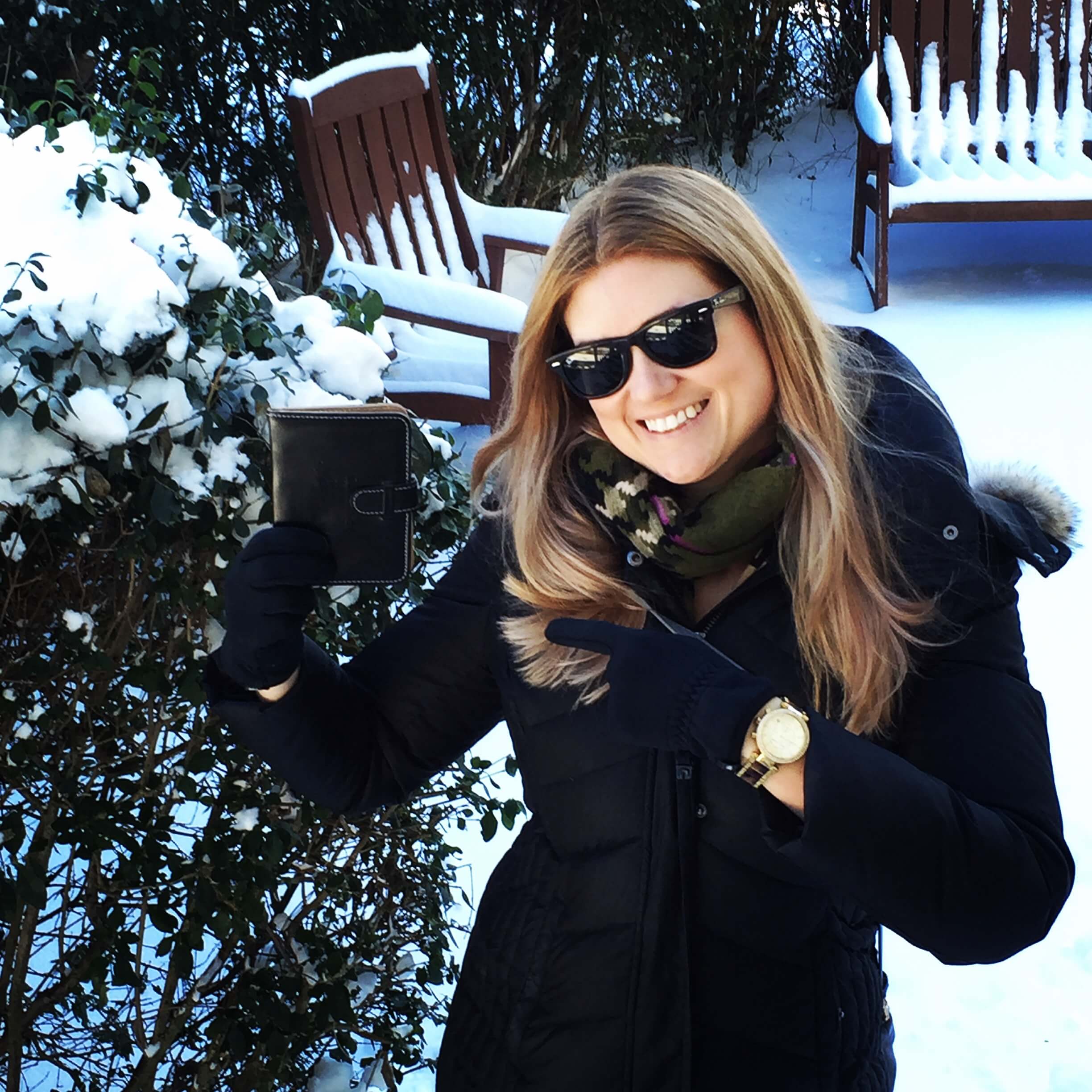 A women in holding a passport in the snow