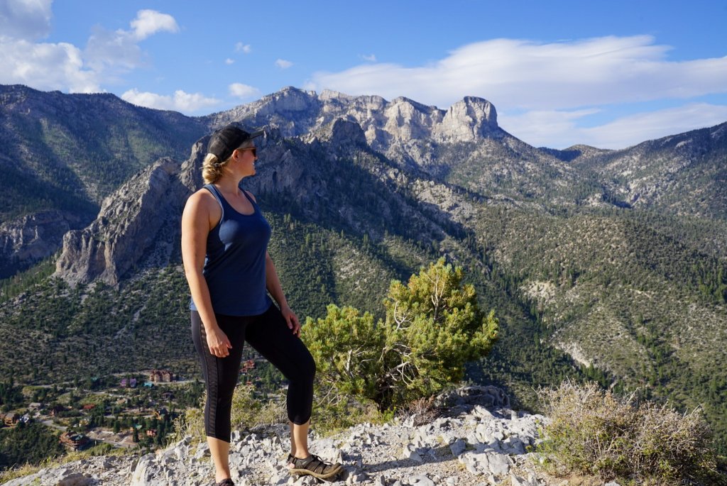 woman standing on Cathedral Rock trail with a mountain in the background