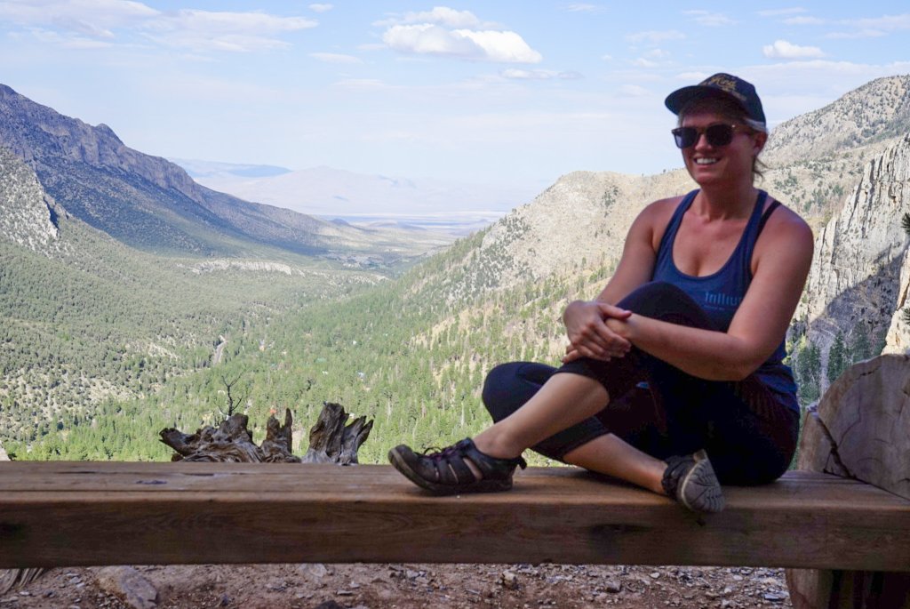 a woman sitting on a trail