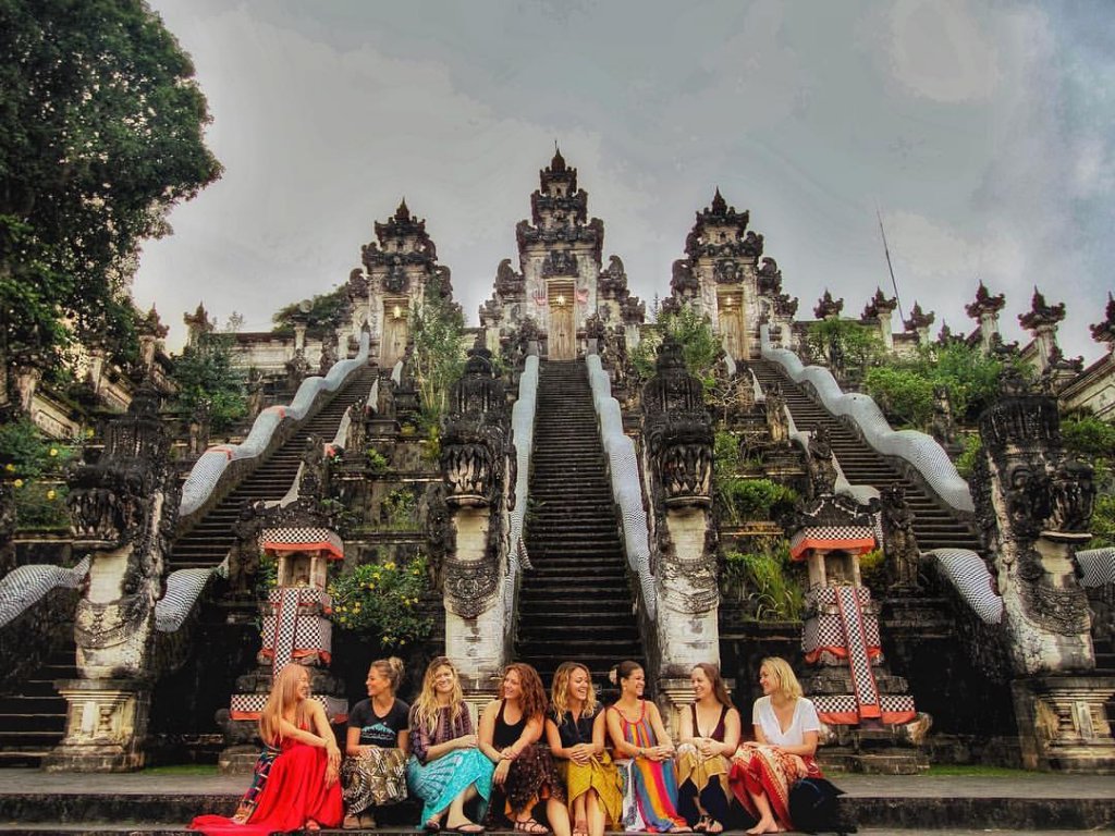 women sitting on the stairs of a temple in Bali