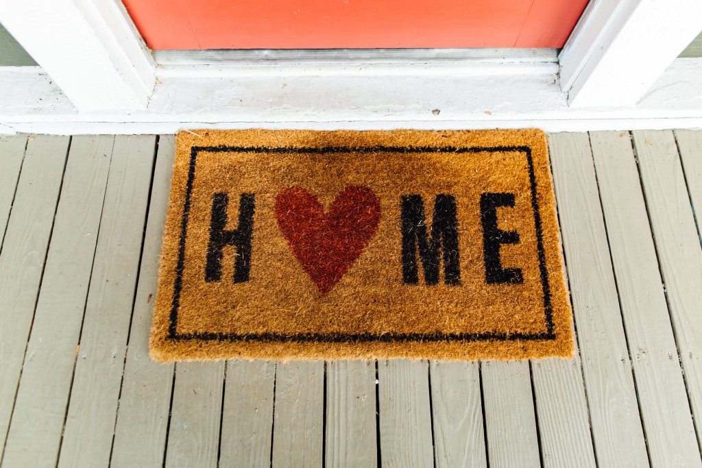 welcome mat that says "home"