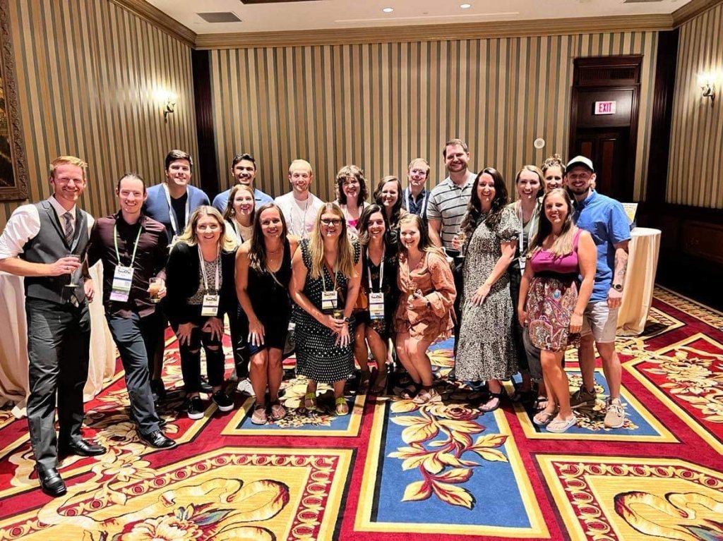 a group of people standing together at TravCon
