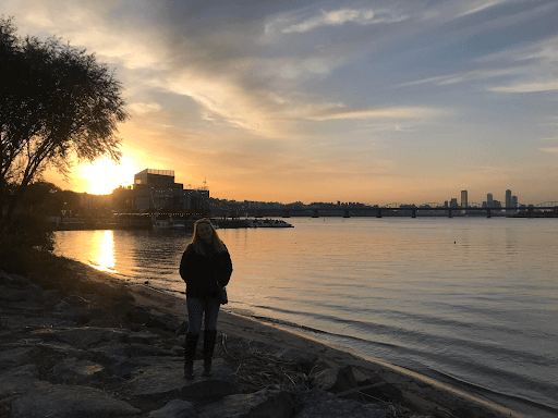 a women standing next to a body of water 