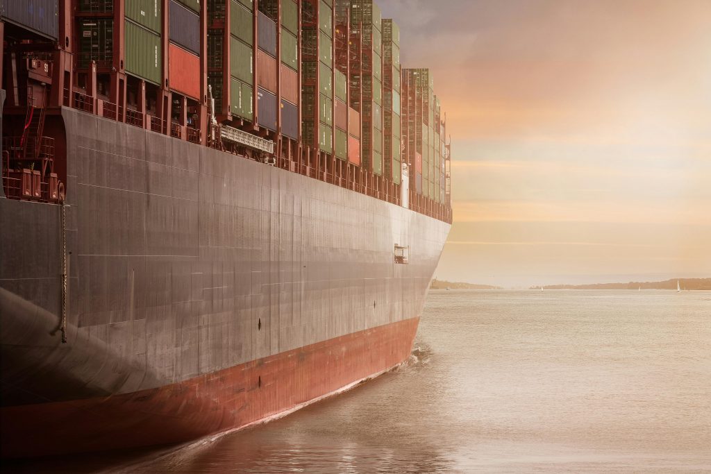 a picture of a cargo ship carrying cargo pods over the ocean