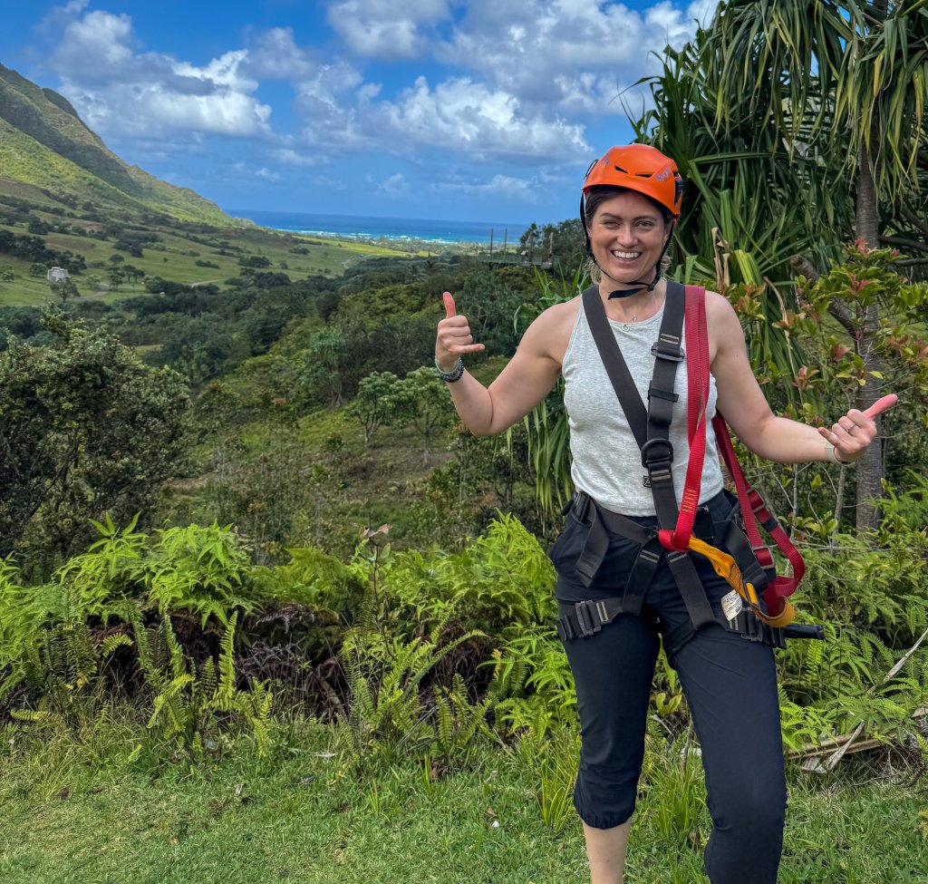 a woman in ziplining gear