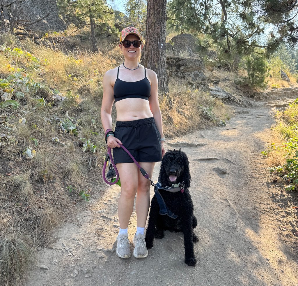 a woman and her dog on a trail
