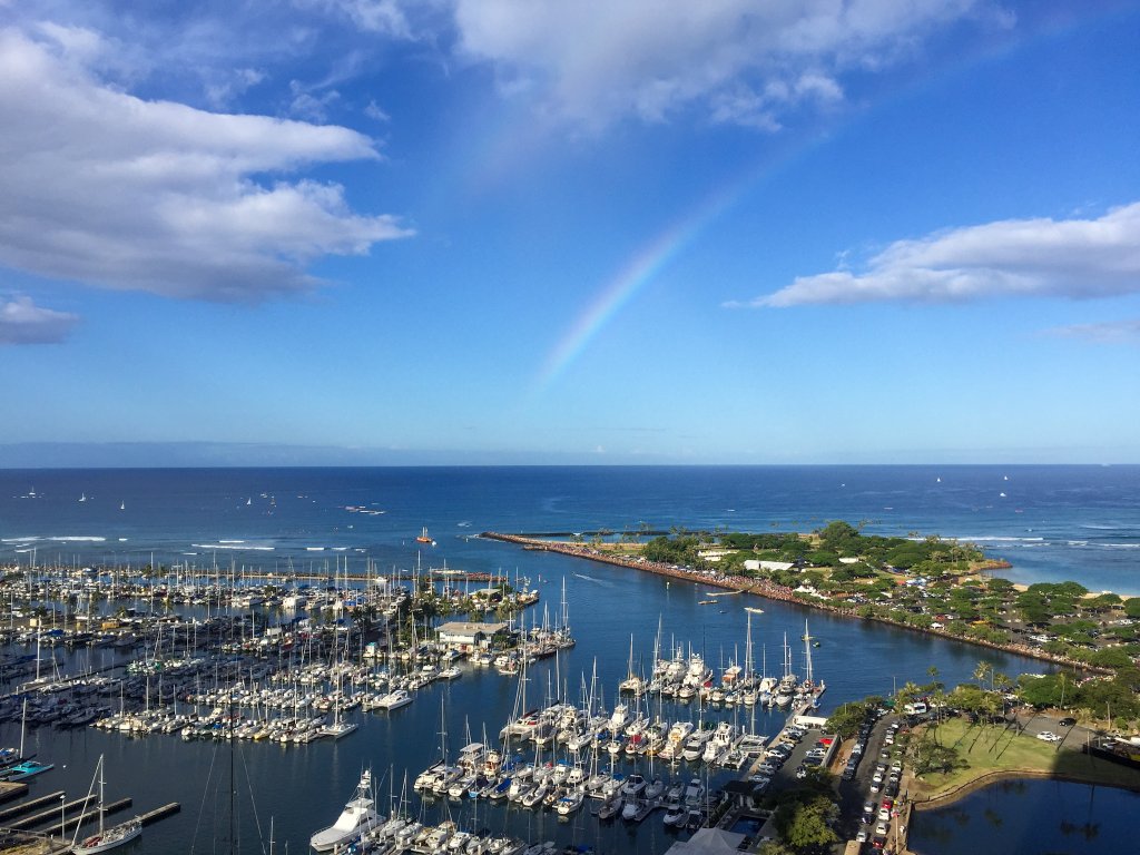 a rainbow over a boat marina