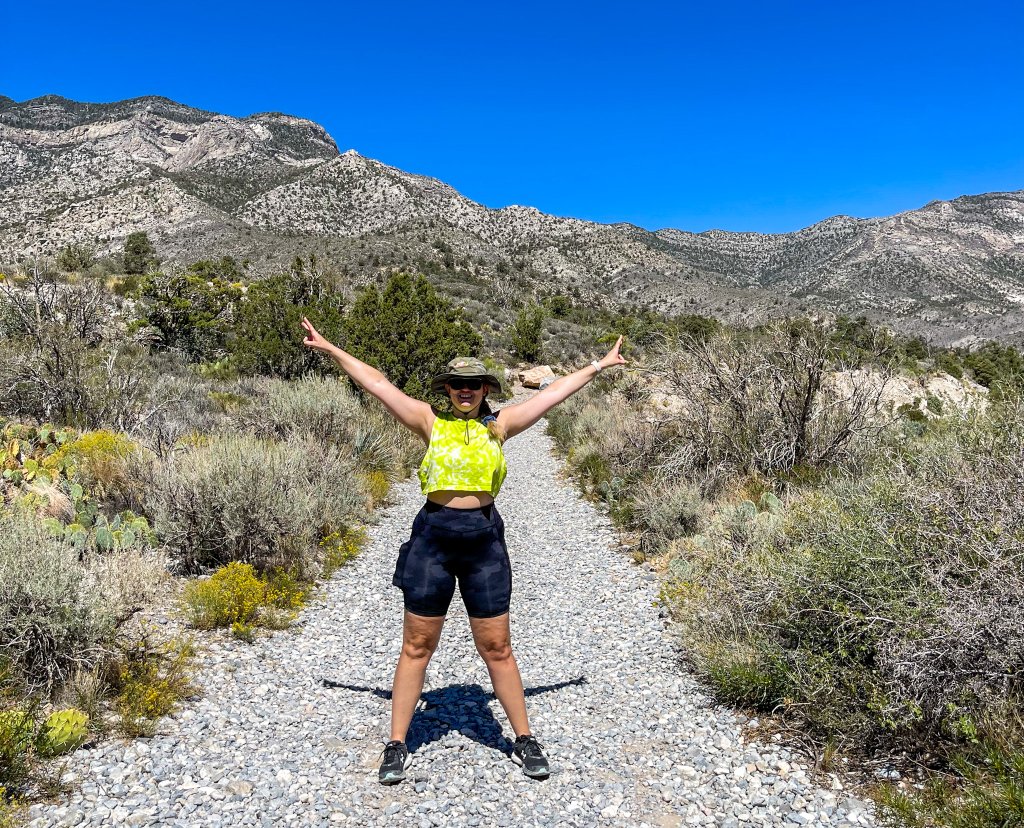 a woman standing in red rocks in las vegas