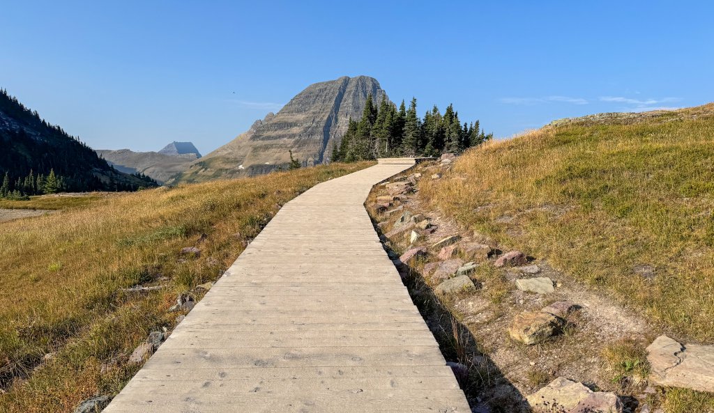 a boardwalk with a mountain behind it