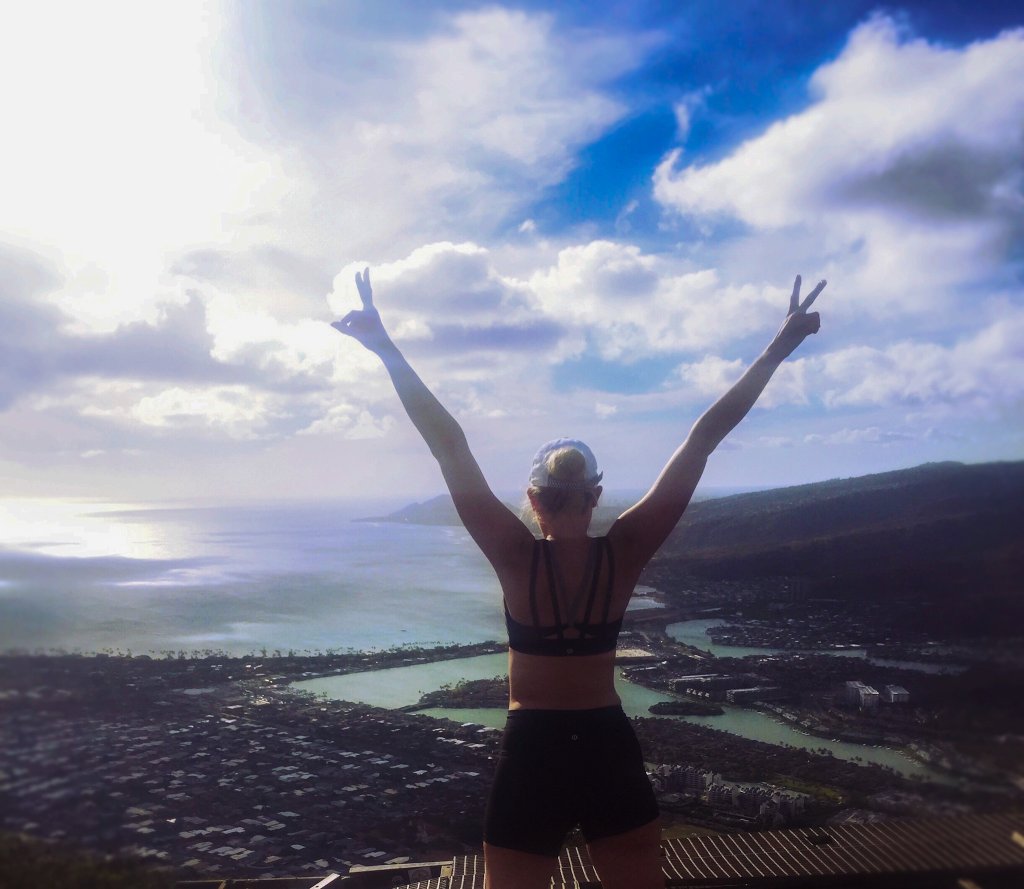 a woman holding her arm in the air