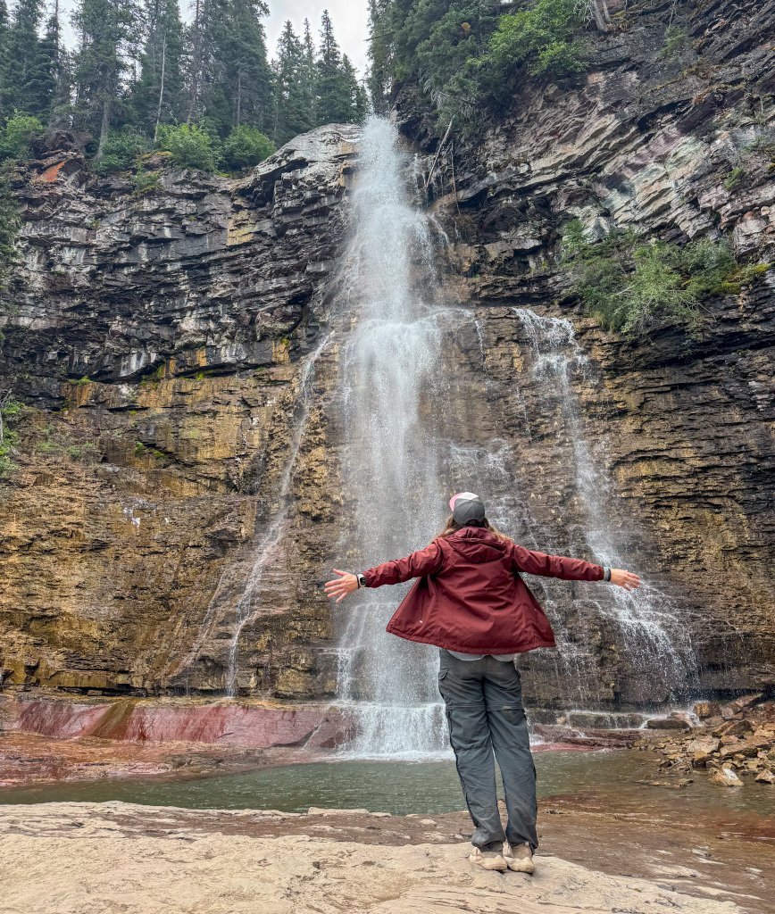 waterfalls with a woman standing in front