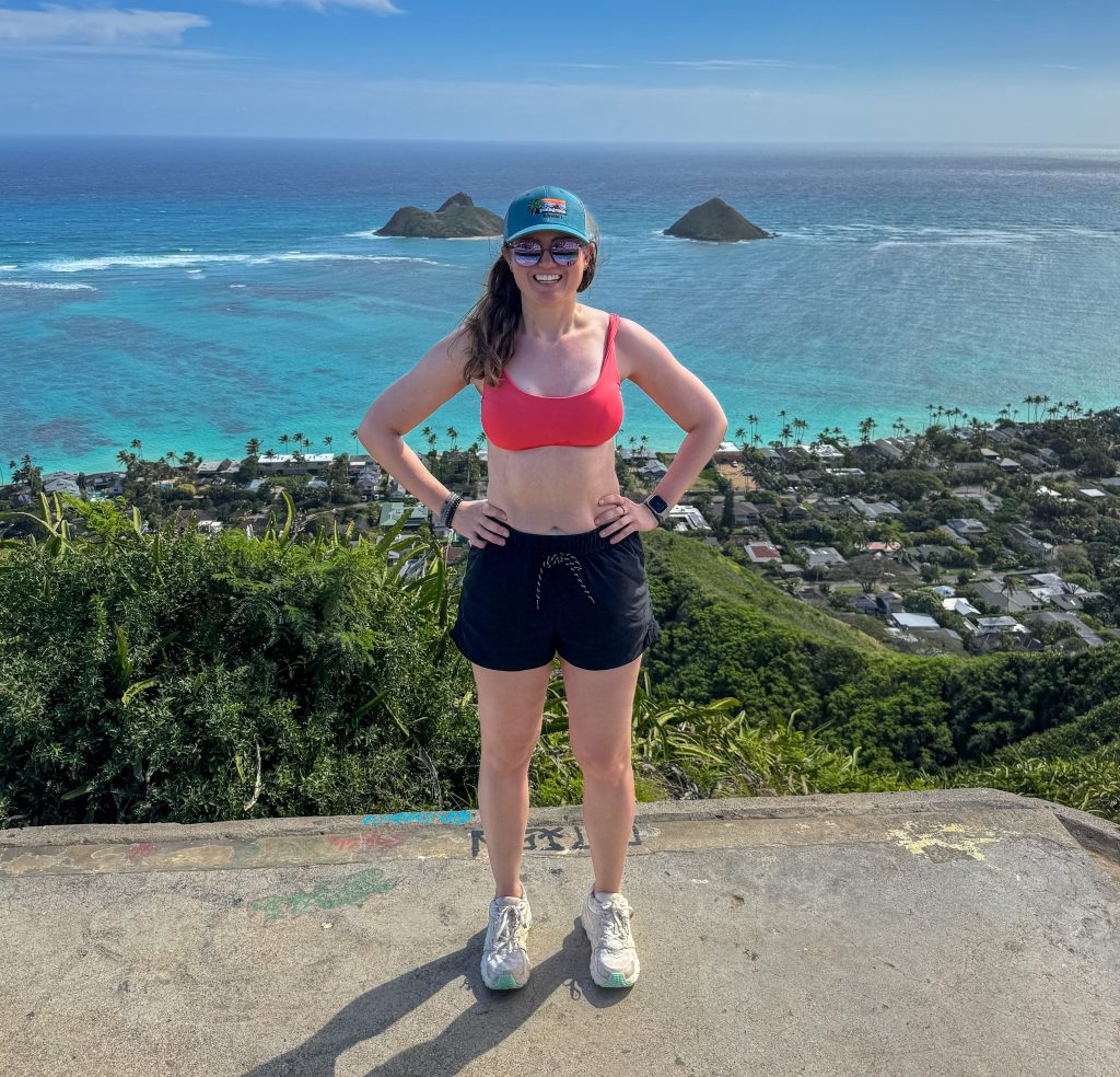 a woman standing in front of the ocean