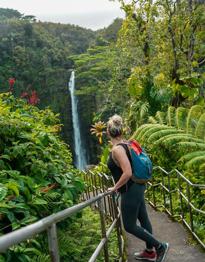 a woman standing at a waterfalls
