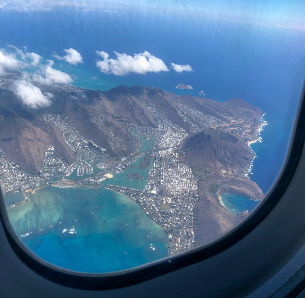 a view of Oahu from the window of an airplen
