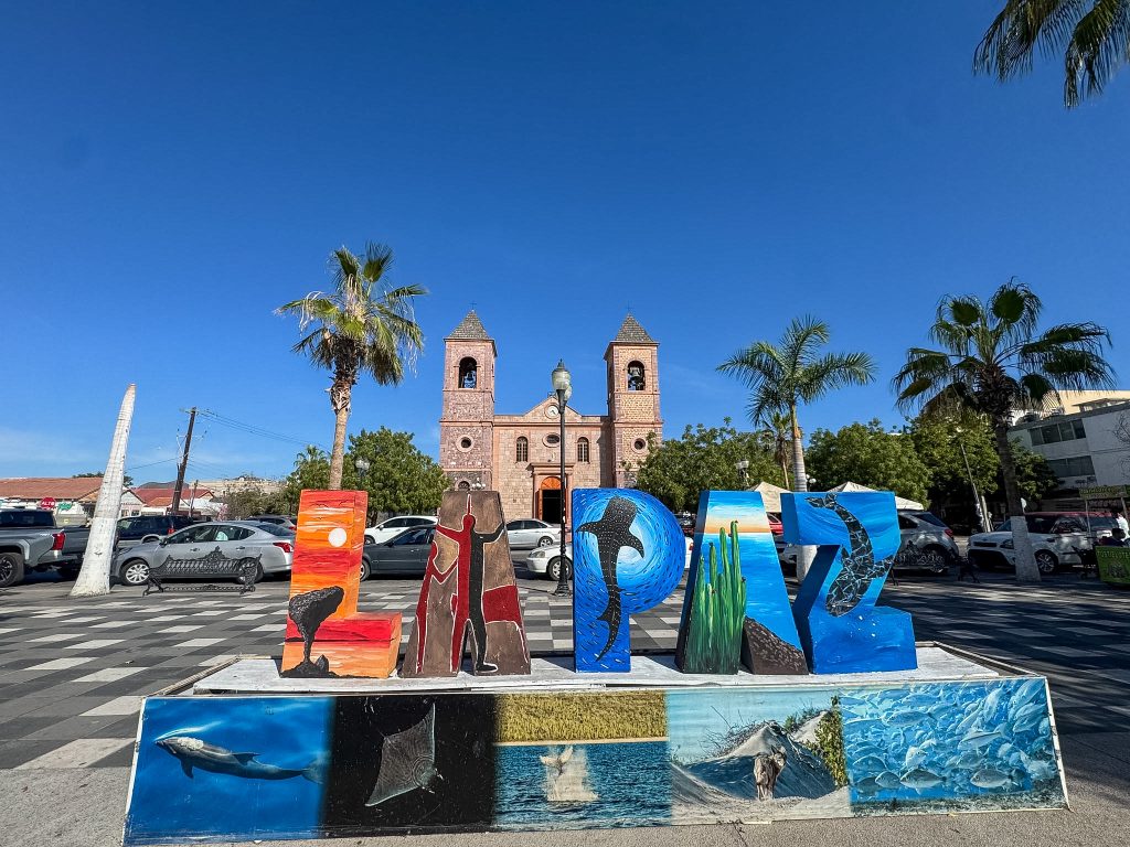 a sign that says La Paz in front of a cathedral